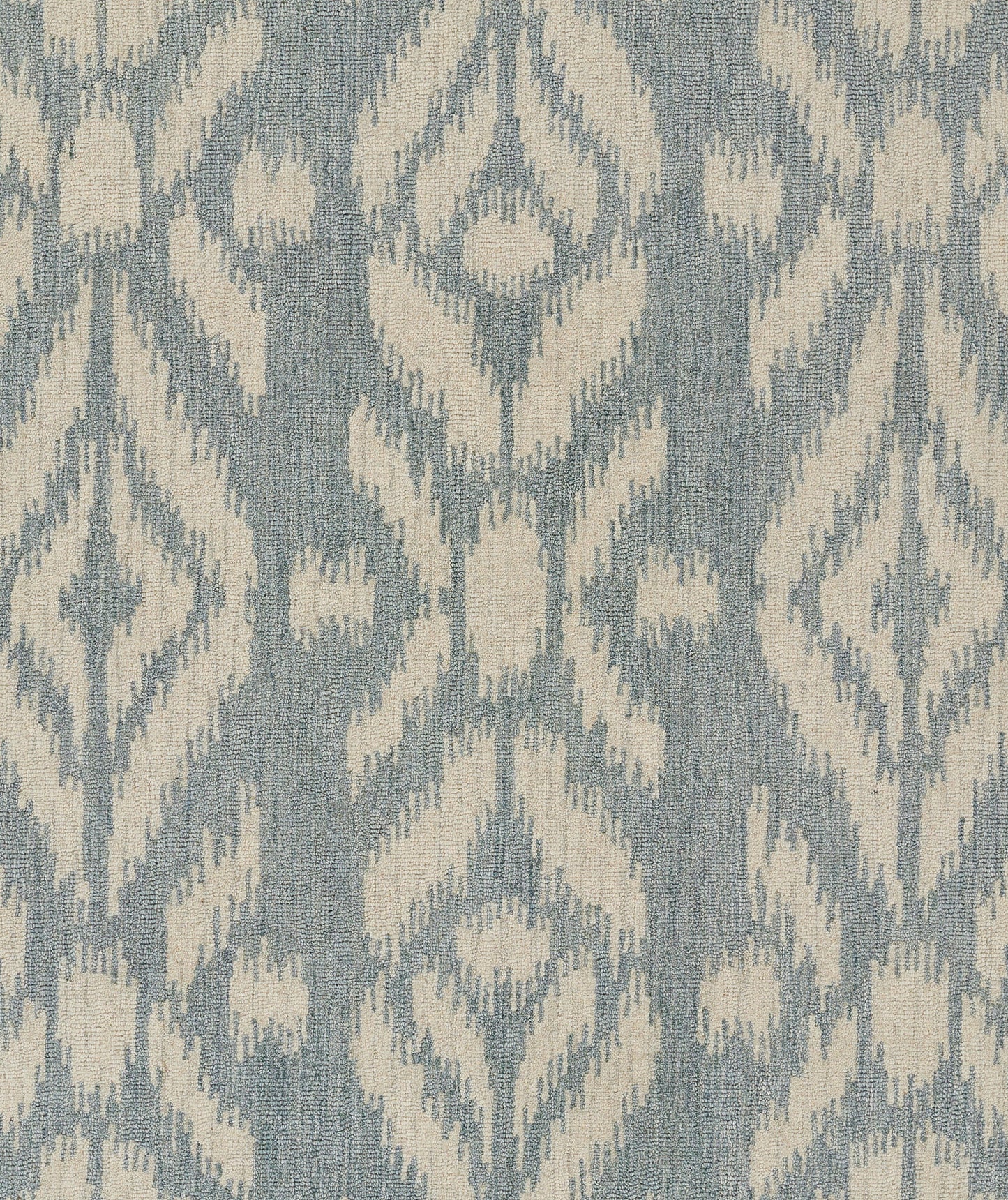 Blue-gray woven rug with ivory ikat-inspired geometric pattern; decorative 5' x 8' rug.
