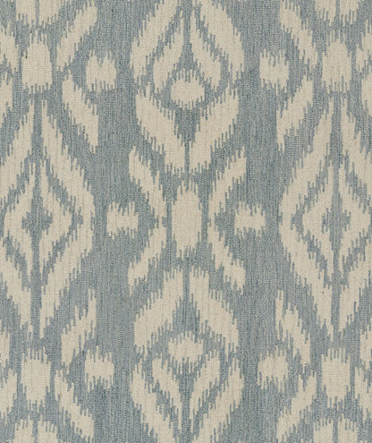 Blue-gray woven rug with ivory ikat-inspired geometric pattern; decorative 5' x 8' rug.