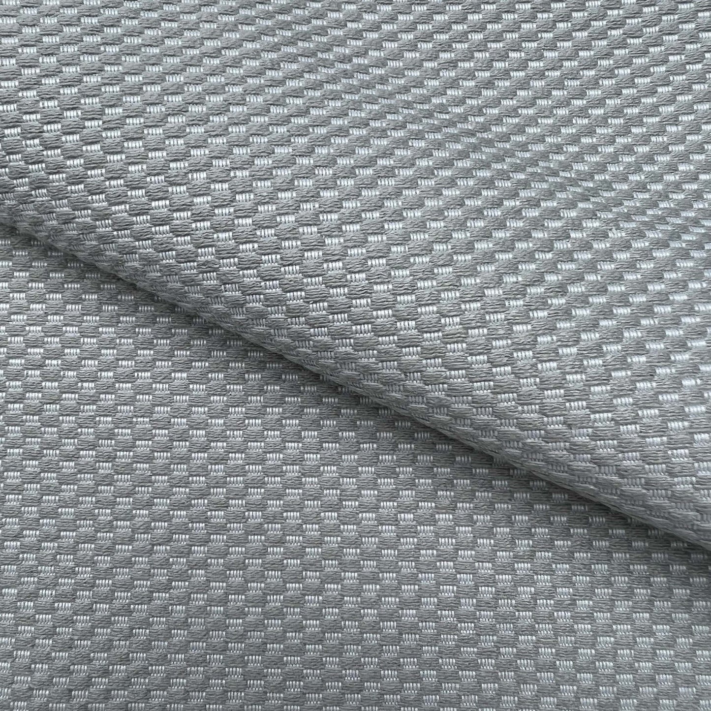 Gray woven fabric with a small checker pattern; soft, durable upholstery texture.