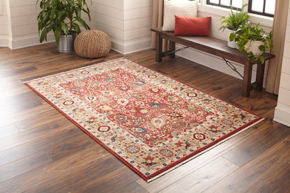 Rectangular oriental-style runner in red, cream and blue with a floral medallion pattern; on wood floor in a sunny living room.