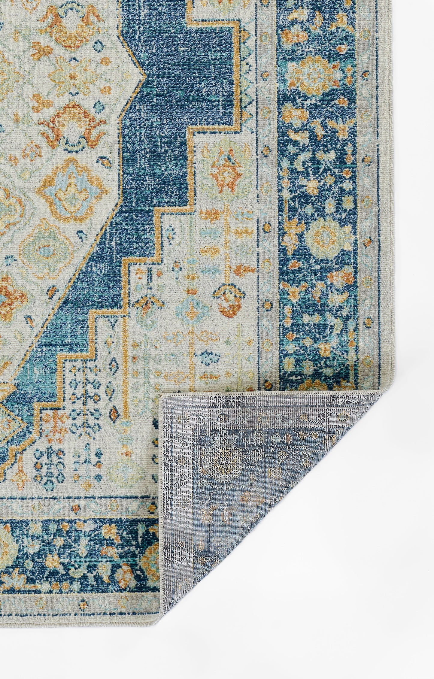Blue & ivory oriental rug with floral motifs & geometric borders; reversible weave, fold showing underside.