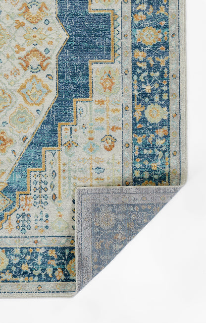 Blue & ivory oriental rug with floral motifs & geometric borders; reversible weave, fold showing underside.