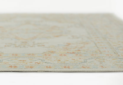 Beige floral area rug (2' x 3') with subtle blue & orange accents, close-up edge view, soft low-pile fabric.