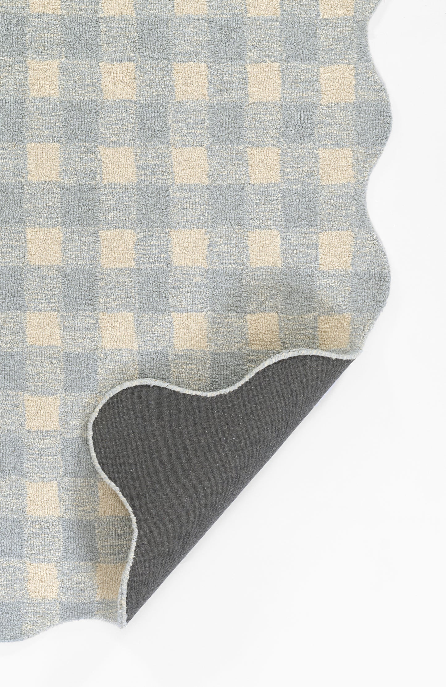 Light blue and cream gingham cotton fabric swatch with curved edge and white stitched border; dark grey backing.