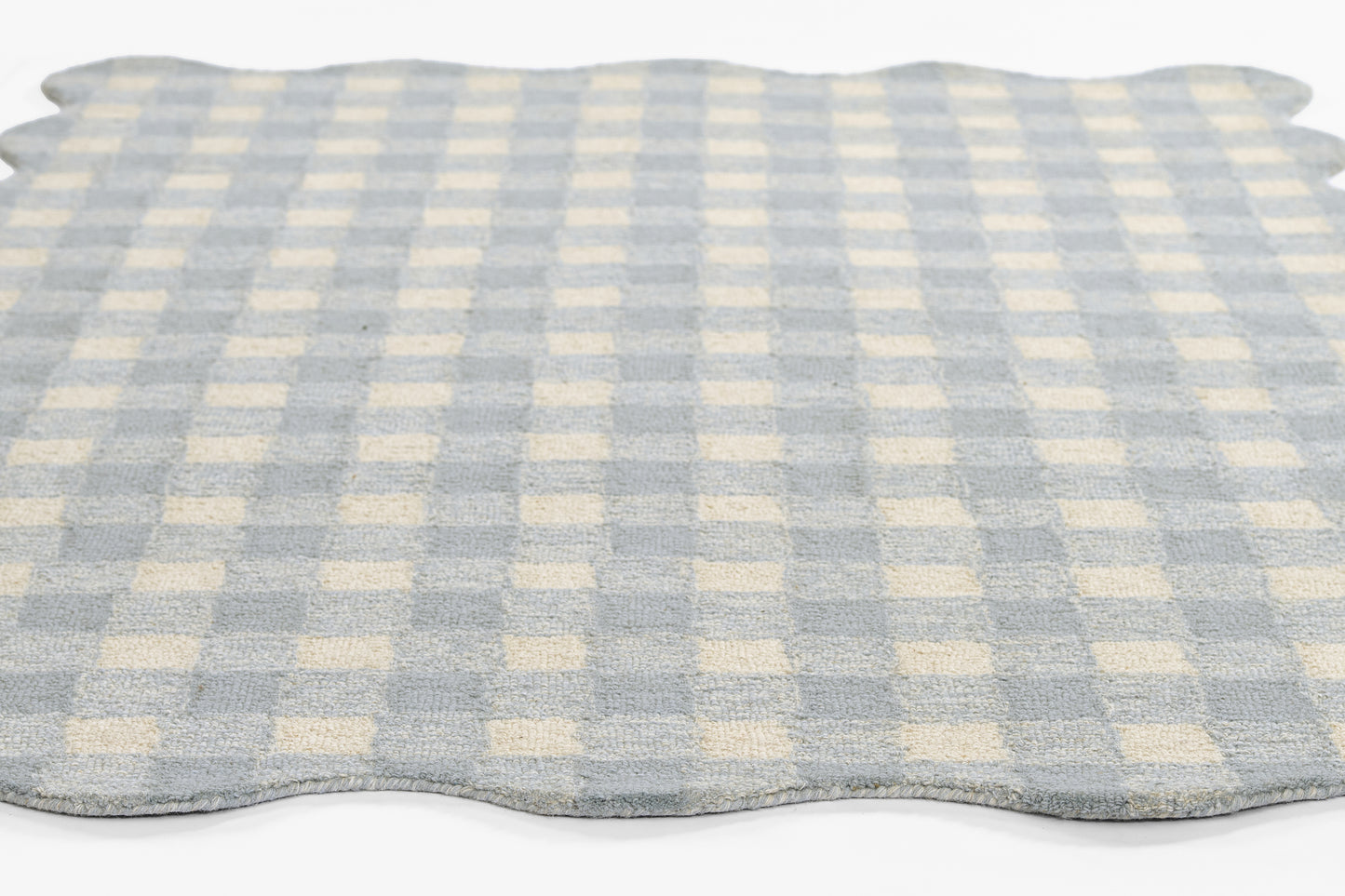 Blue and cream checkered rug with scalloped edges, soft cotton texture for kitchen or bath.
