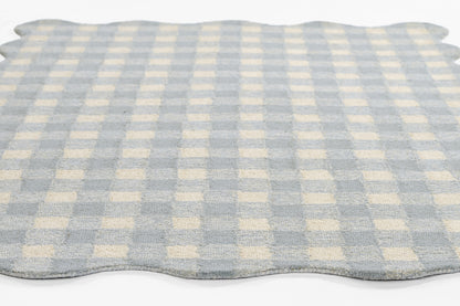 Soft blue and white gingham runner with scalloped edges and woven texture.