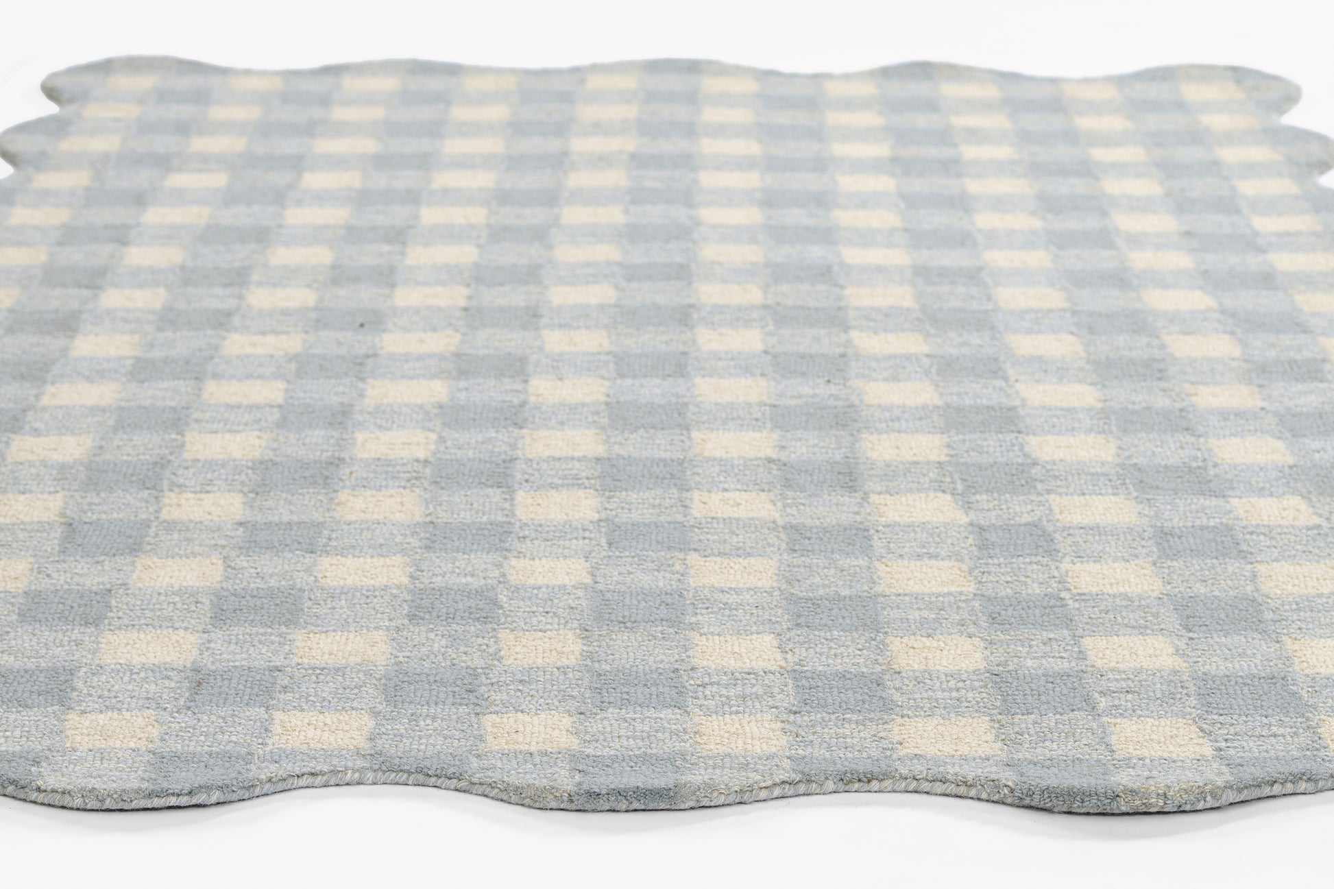 Light blue and ivory gingham rug with scalloped edges, soft fabric, rectangular.