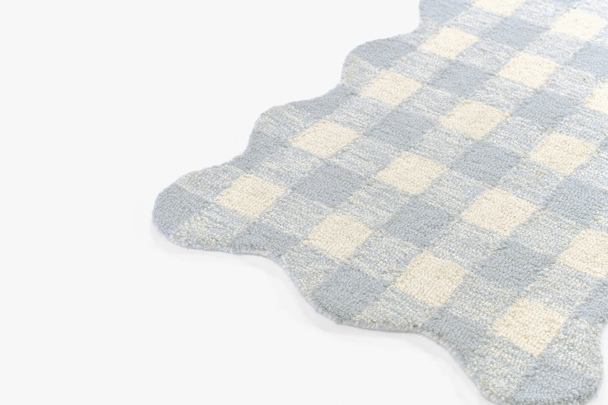 Soft blue and cream checkered rug with scalloped edges and plush texture; 9' x 12' area rug for cozy home decor.