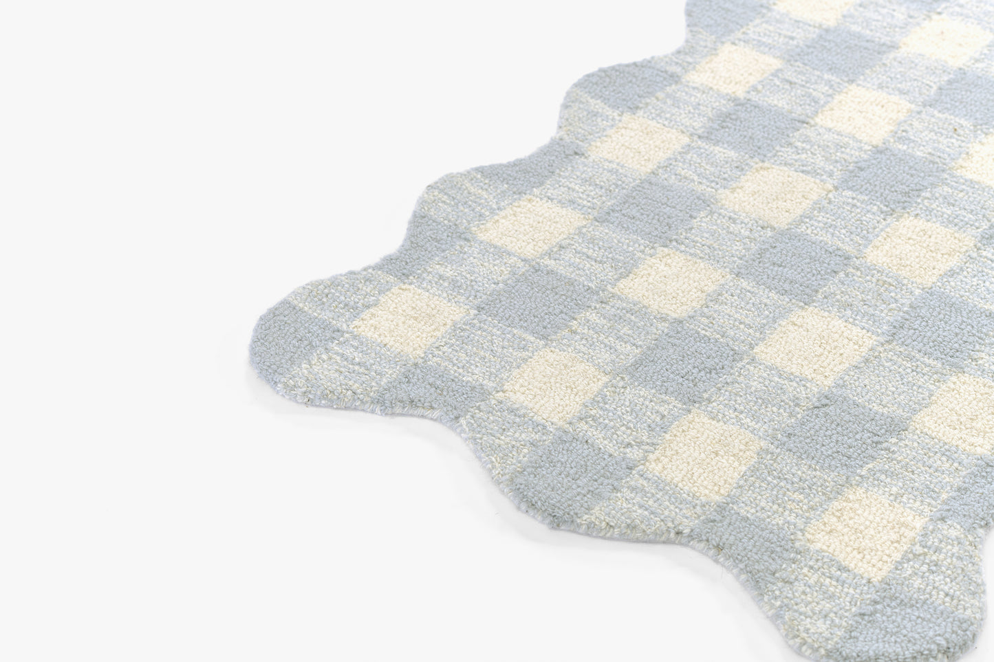 Light blue and cream gingham rug with scalloped edge; soft plush fabric for bathroom or bedroom decor.