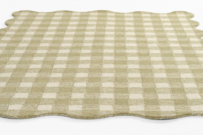 Beige and cream gingham rug with scalloped wavy edges.
