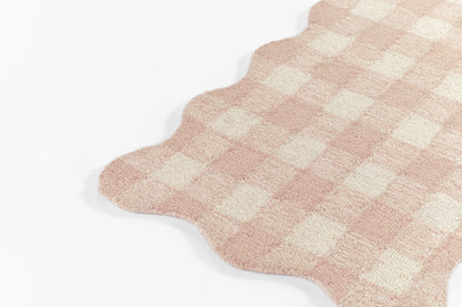 Soft pink checkered plush runner rug with scalloped edge; cream and pink squares.