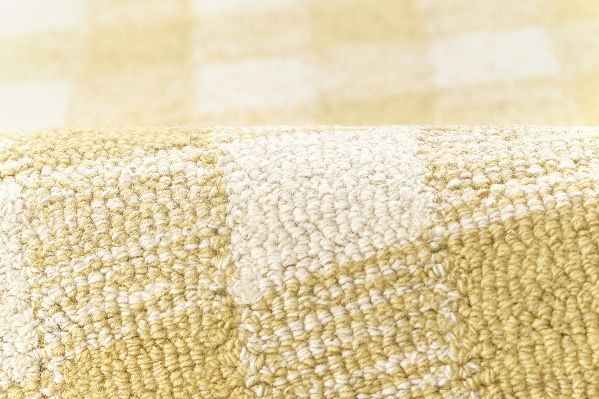 Close-up of yellow and white checkered rug with a soft, looped texture.