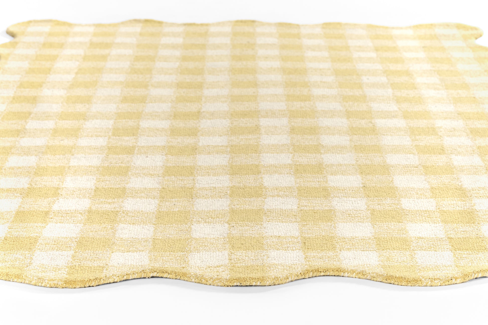 Yellow gingham check rug runner with a wavy scalloped edge.