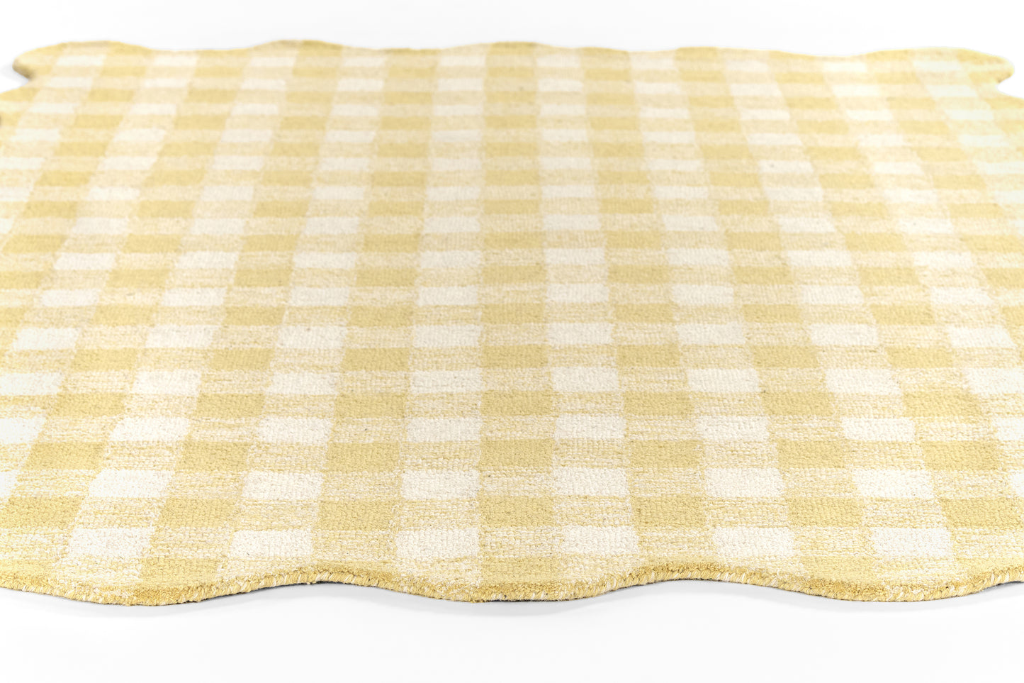 Yellow and white gingham round rug with a scalloped edge, laid flat.