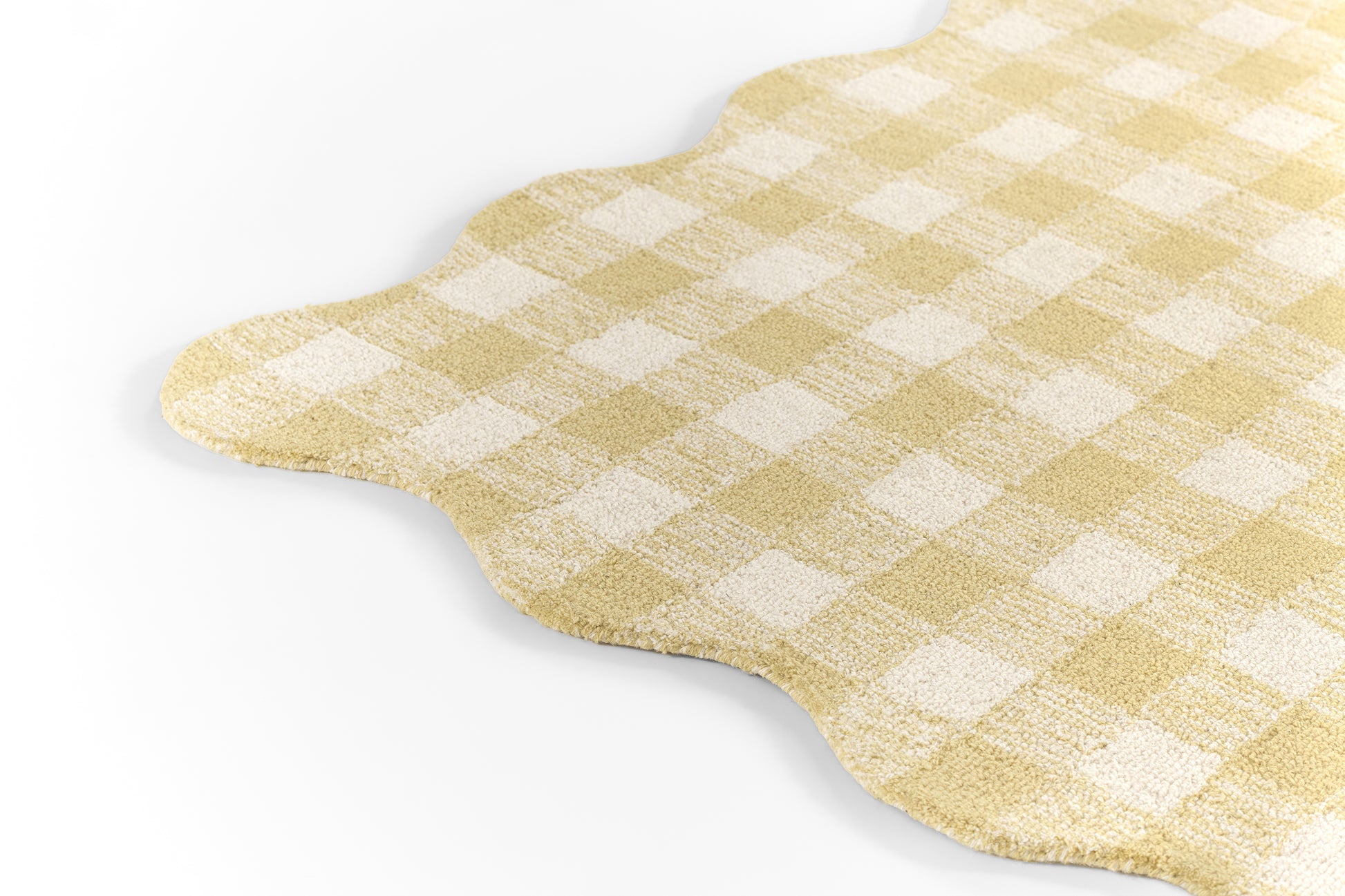 Yellow and white gingham fabric placemat with scalloped edge.