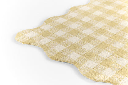 Yellow and white gingham fabric placemat with scalloped edge.