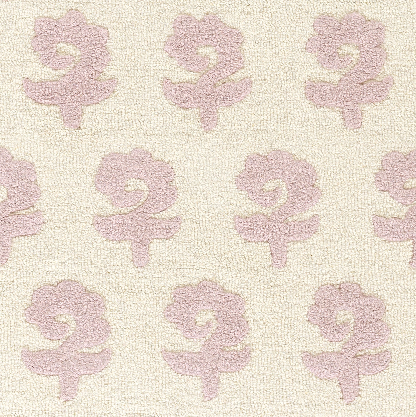 Cream rug with pale pink repeating floral jacquard motifs and a textured surface.