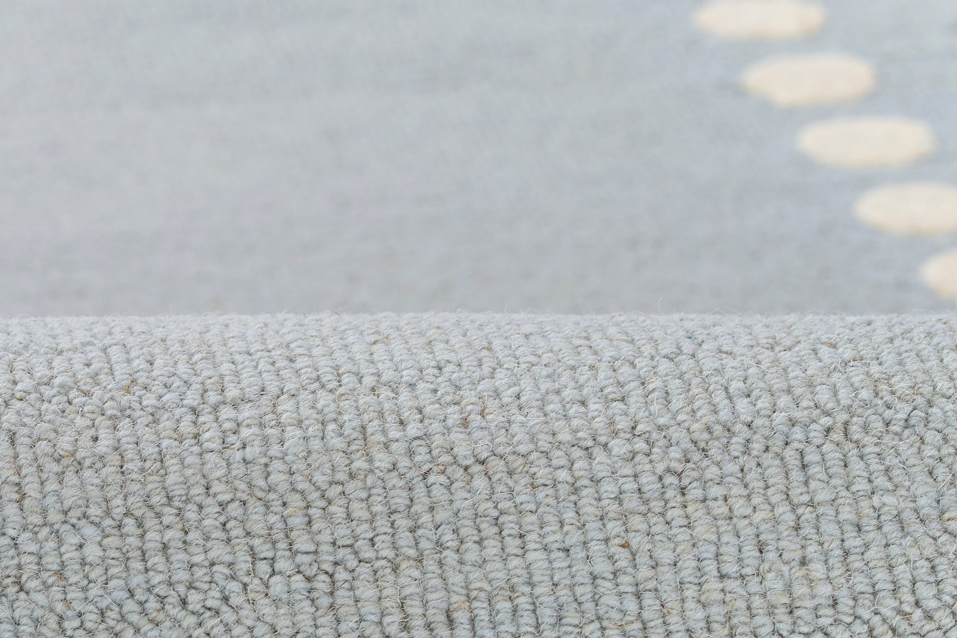 Close-up of light blue-gray loop-pile rug with soft textured fibers, modern casual decor.