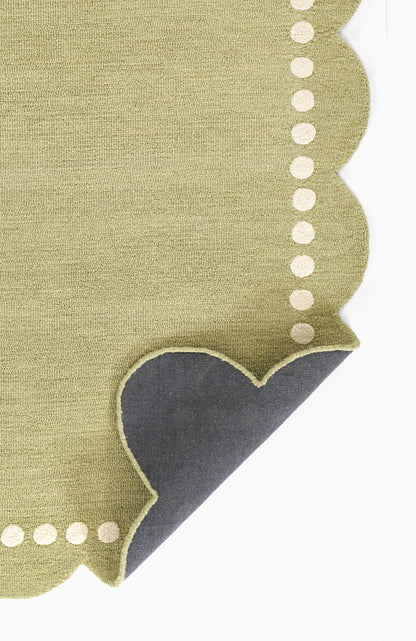 Olive green rug featuring a dark blue corner accent and white dotted trim, size 5' x 8'.