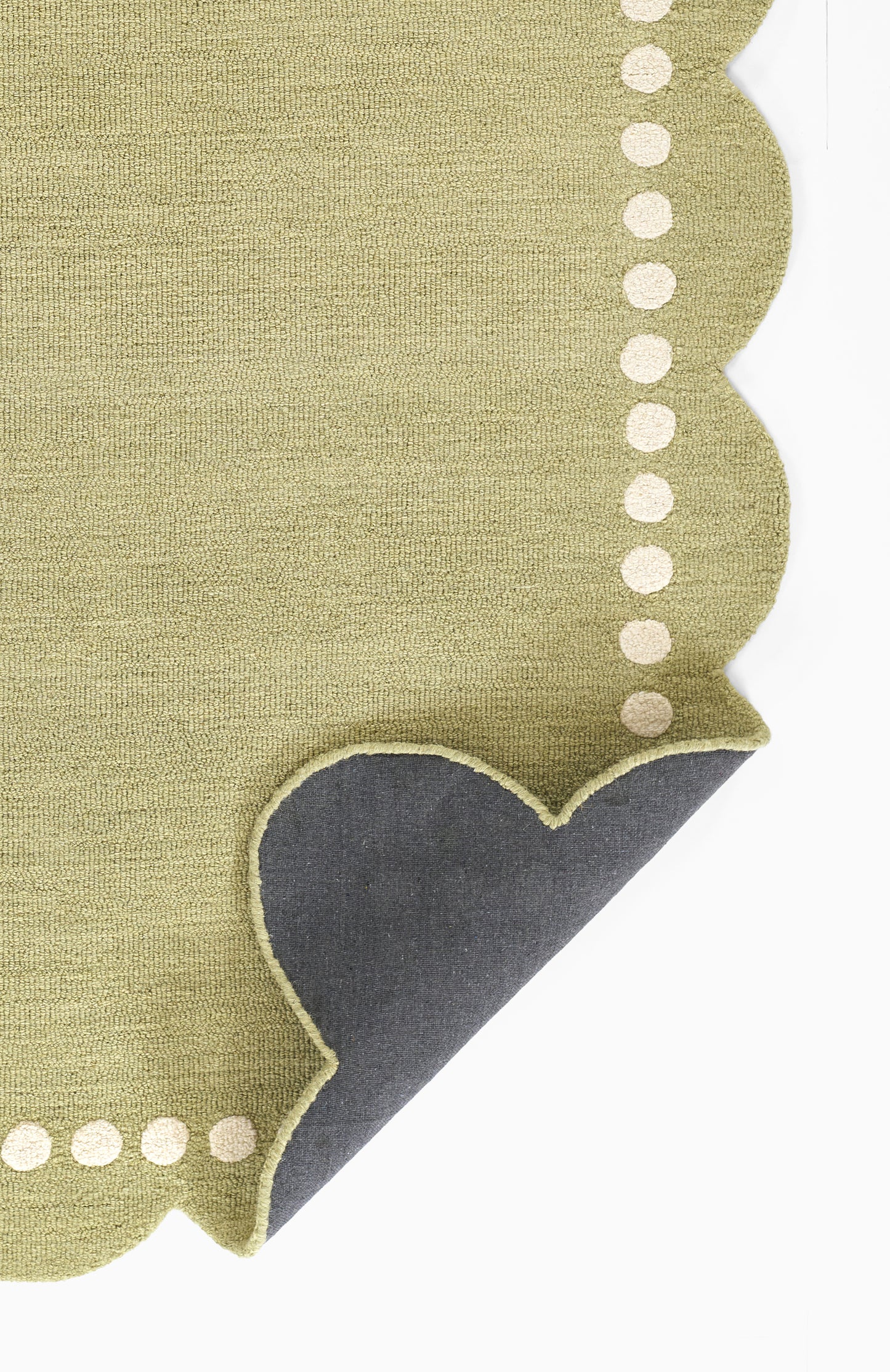 Olive-green linen napkin with scalloped edge & white dotted trim & dark gray underside.