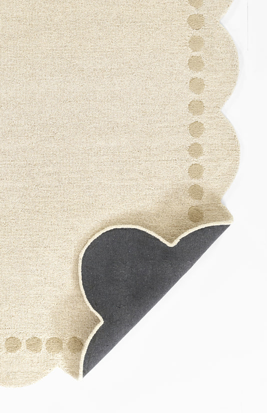 Beige linen napkin with scalloped border & dotted stitching along edges; dark navy corner accent.
