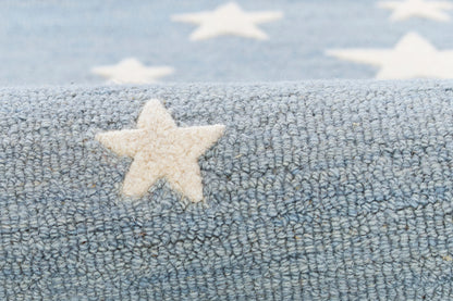 Blue round rug with a white star pattern; soft, plush texture.