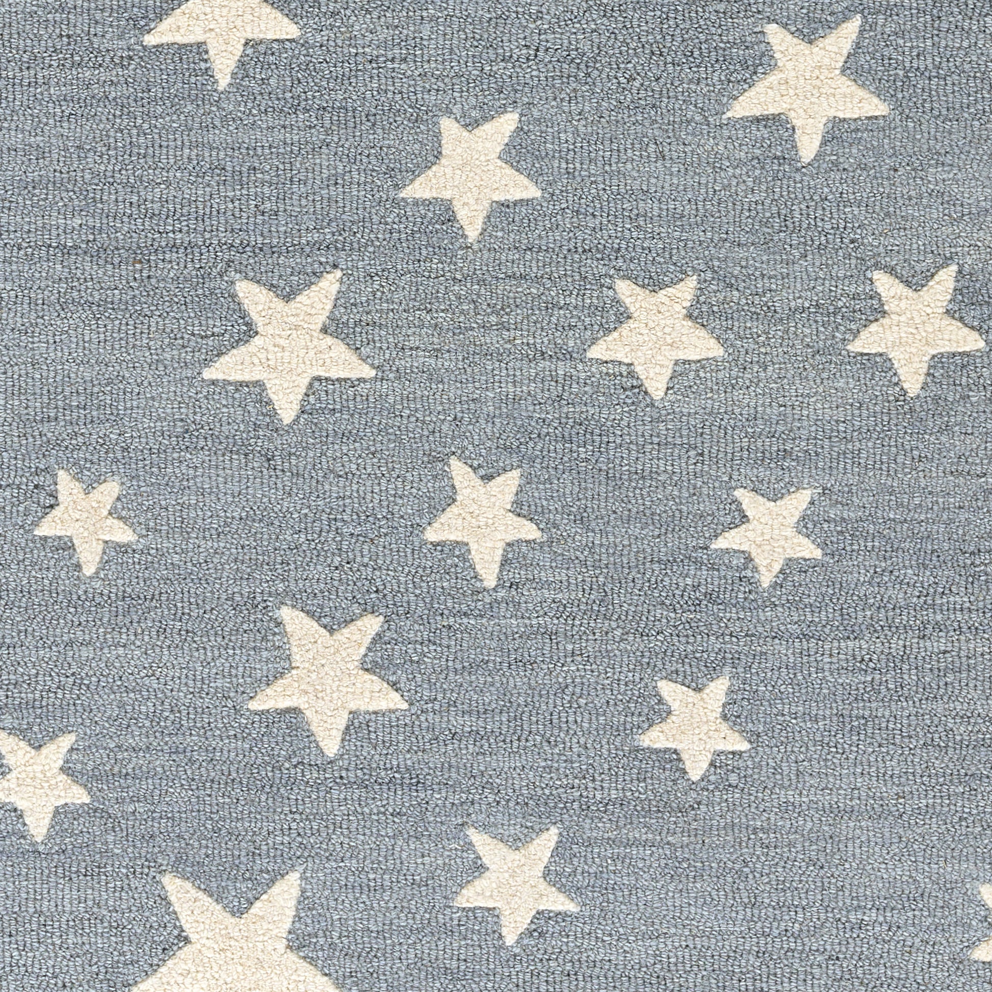 Blue textured fabric with scattered white five-point stars, starry pattern.