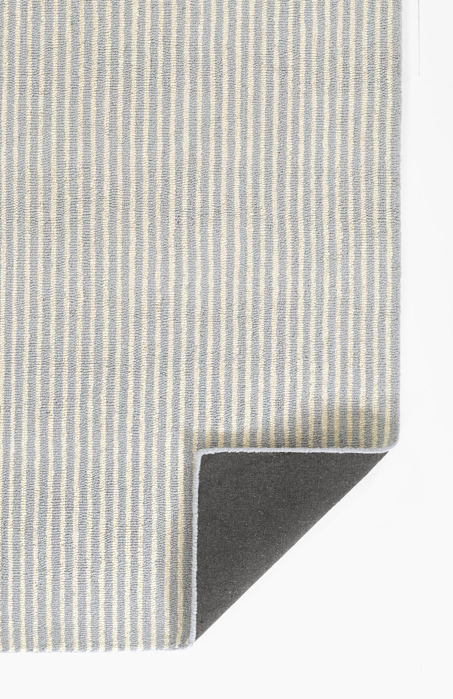 Blue and cream vertical striped rug with folded corner showing the dark underside; 2' x 3'.