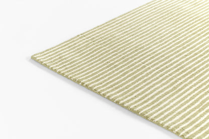 Close-up of an olive-green and cream striped woven rug corner with a textured surface.
