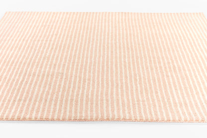 Peach and pink striped woven rug with soft texture.