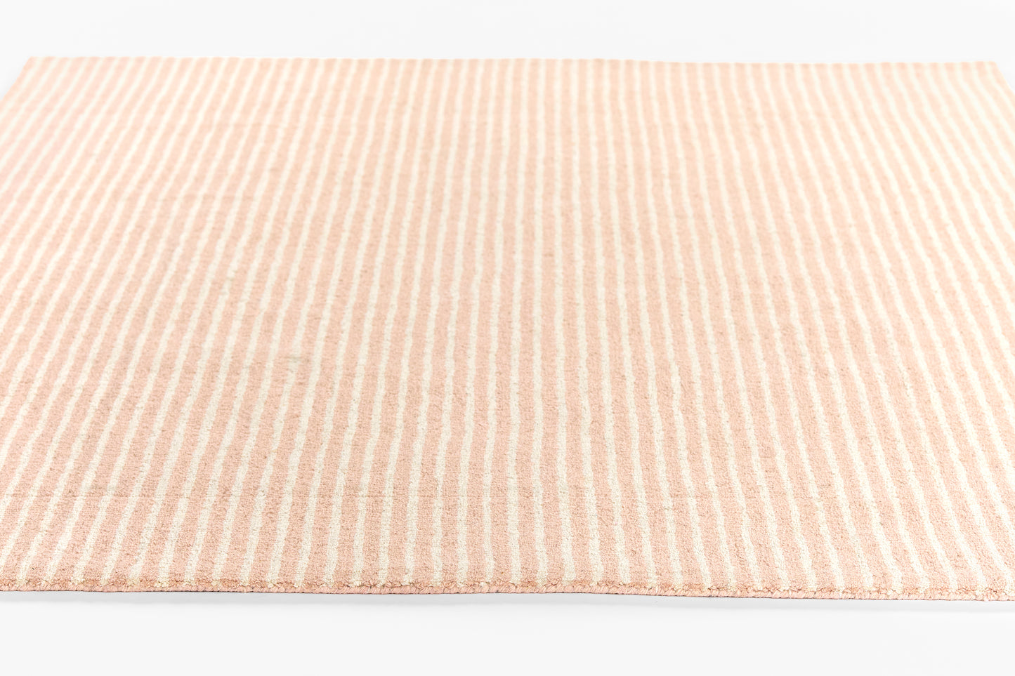 Peach and white striped flat-weave rug, 8' x 10', soft pastel hues, rectangular, ideal for living room or bathroom.