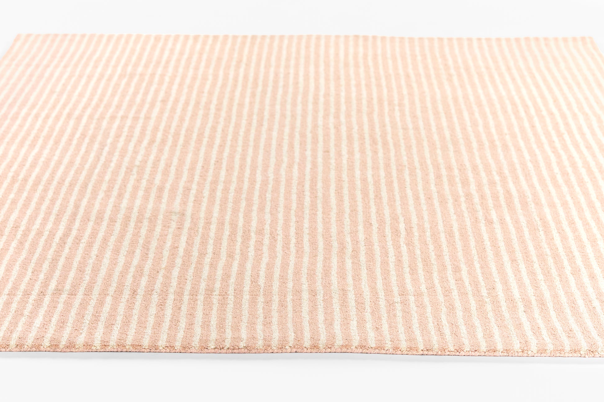 Peach and cream striped woven rug, rectangular, soft-textured rug for living room or bedroom.