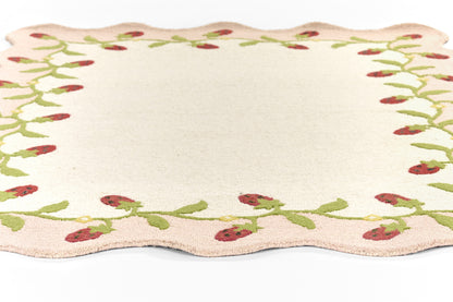 Cream rectangular 2' x 8' runner rug with scalloped edges and a green berry vine border.
