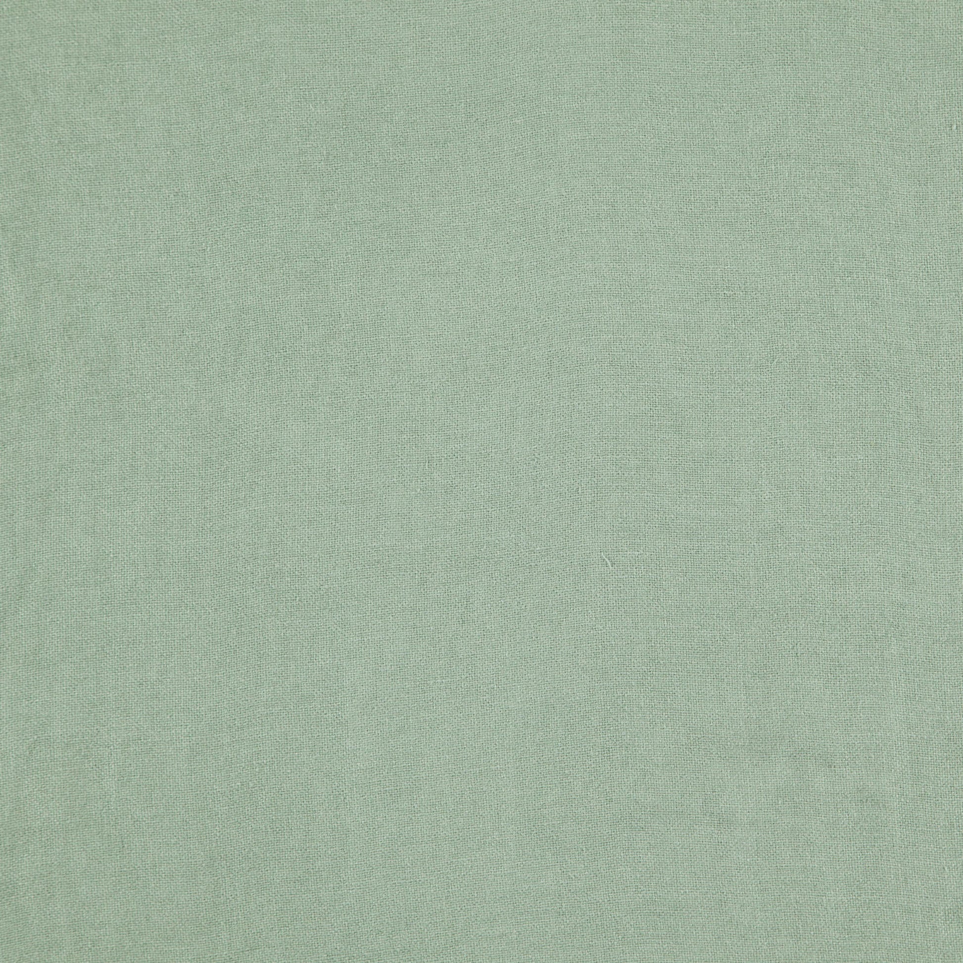 Close-up of light sage green linen fabric with subtle woven texture.