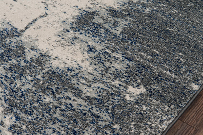 Abstract gray-blue speckled area rug with plush pile; modern style for living spaces.