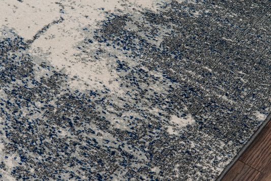 Abstract gray-blue speckled area rug with plush pile; modern style for living spaces.