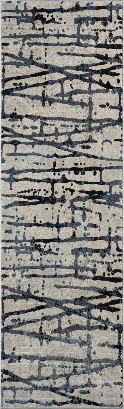 Rectangular rug with abstract dark blue-gray brushstrokes on a light gray background.