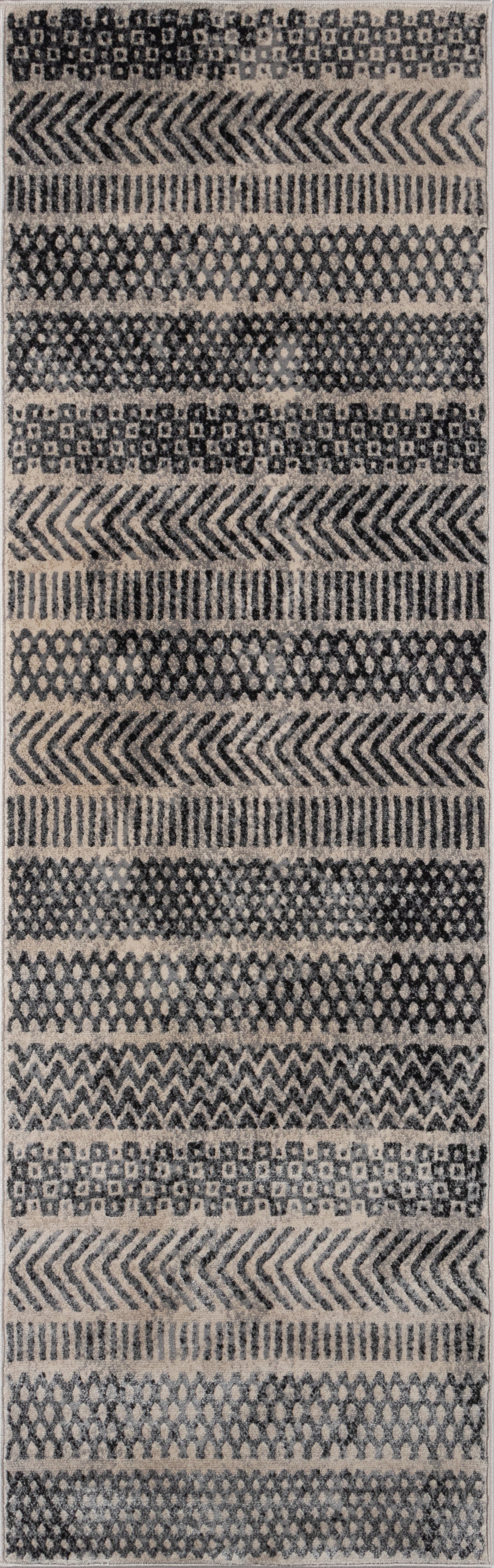 Gray geometric area rug (4' x 6') with repeating chevron, diamond and lattice bands in neutral tones; woven textile.