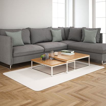 Modern living room: grey sectional sofa with mint cushions, two-tier wooden coffee tables with white metal frames on a beige rug.