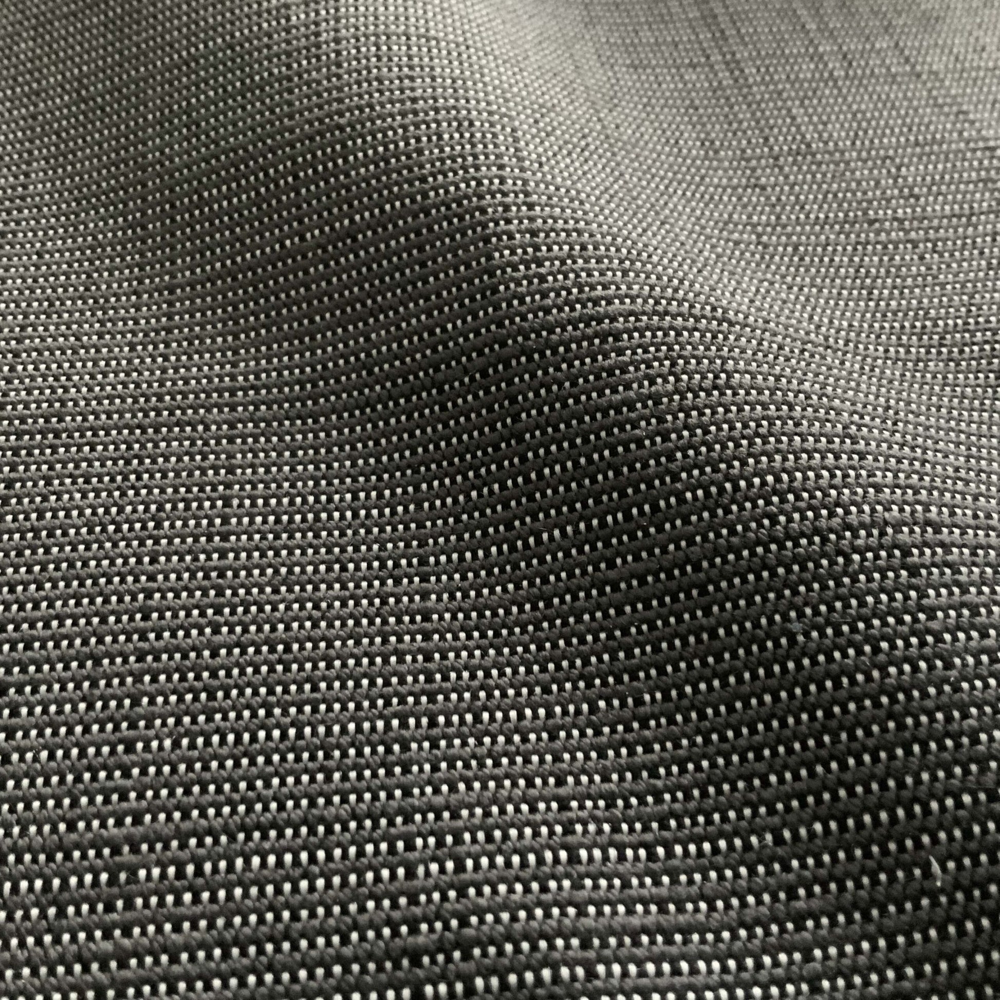 Close-up of charcoal gray, tightly woven outdoor fabric with a linen texture.