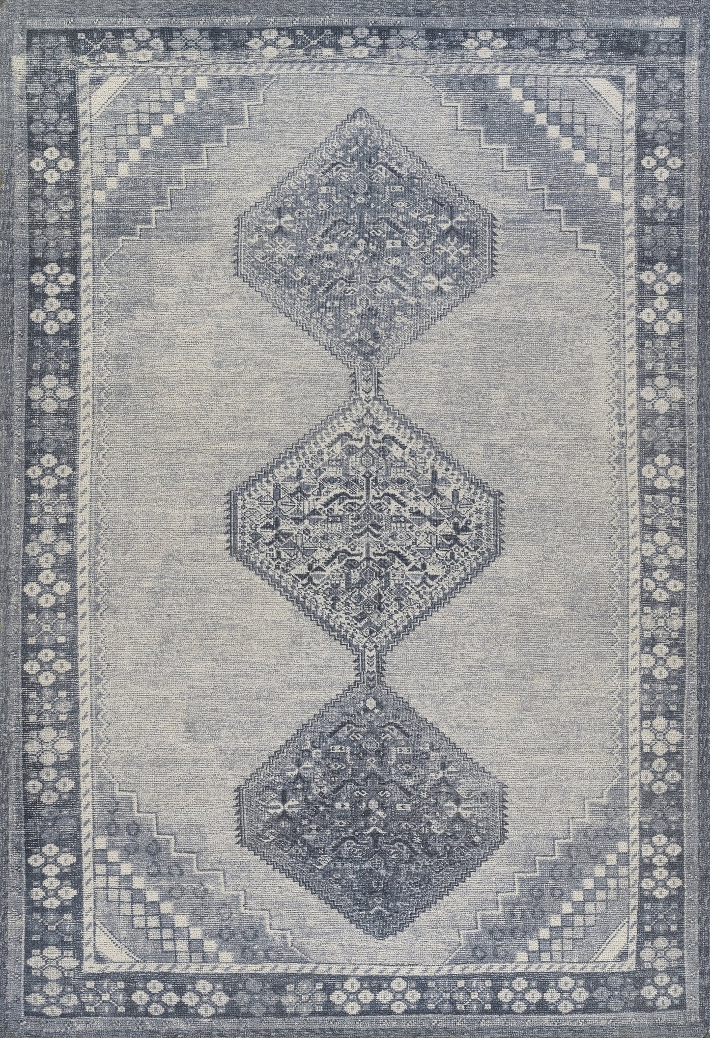Blue-gray distressed area rug with three stacked diamond medallions and floral border; rectangular, traditional style.