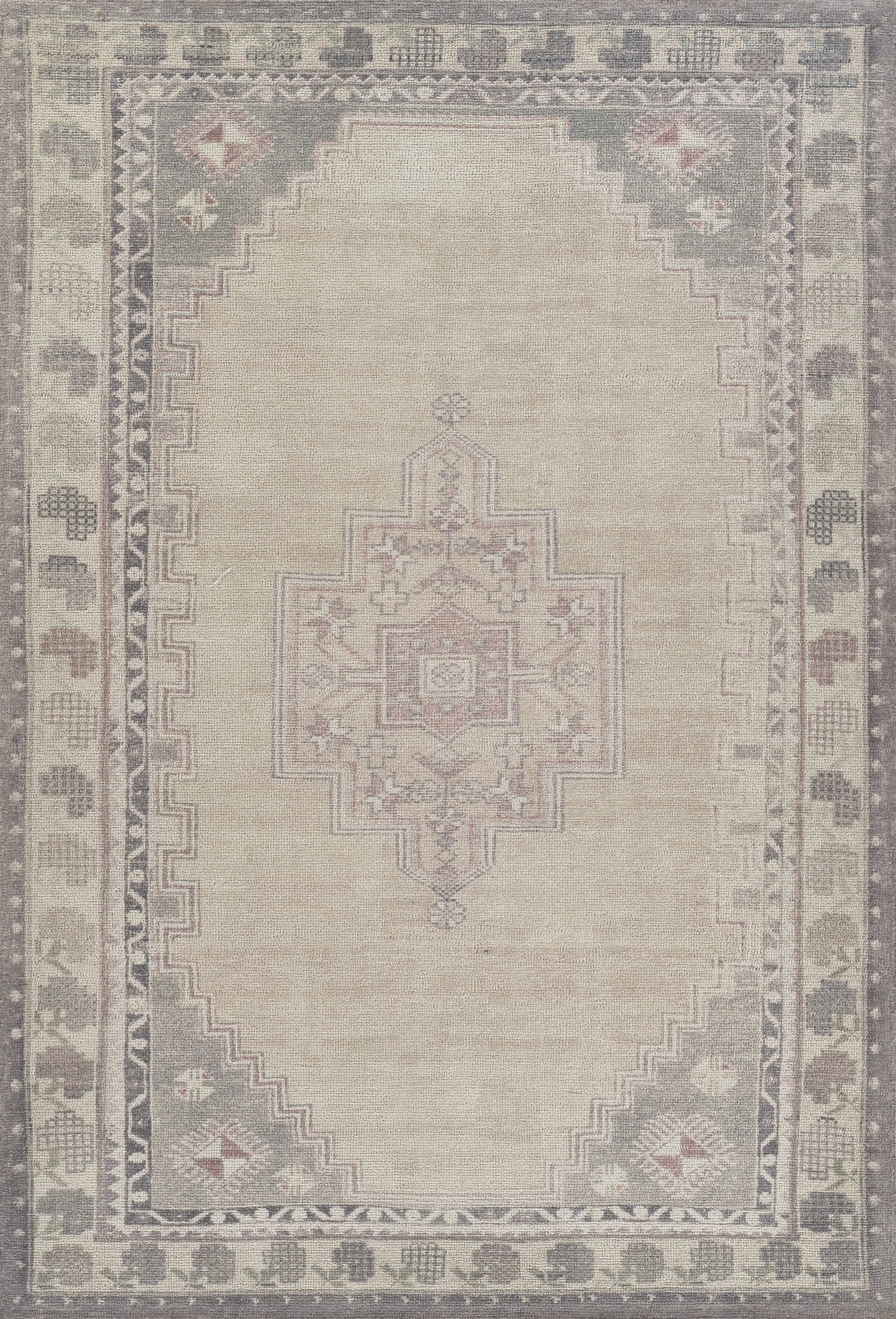 Vintage beige oriental rug with central geometric medallion, muted gray border, and subtle pink/blue corner motifs.