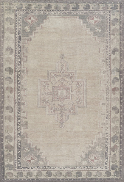 Vintage beige oriental rug with central geometric medallion, muted gray border, and subtle pink/blue corner motifs.
