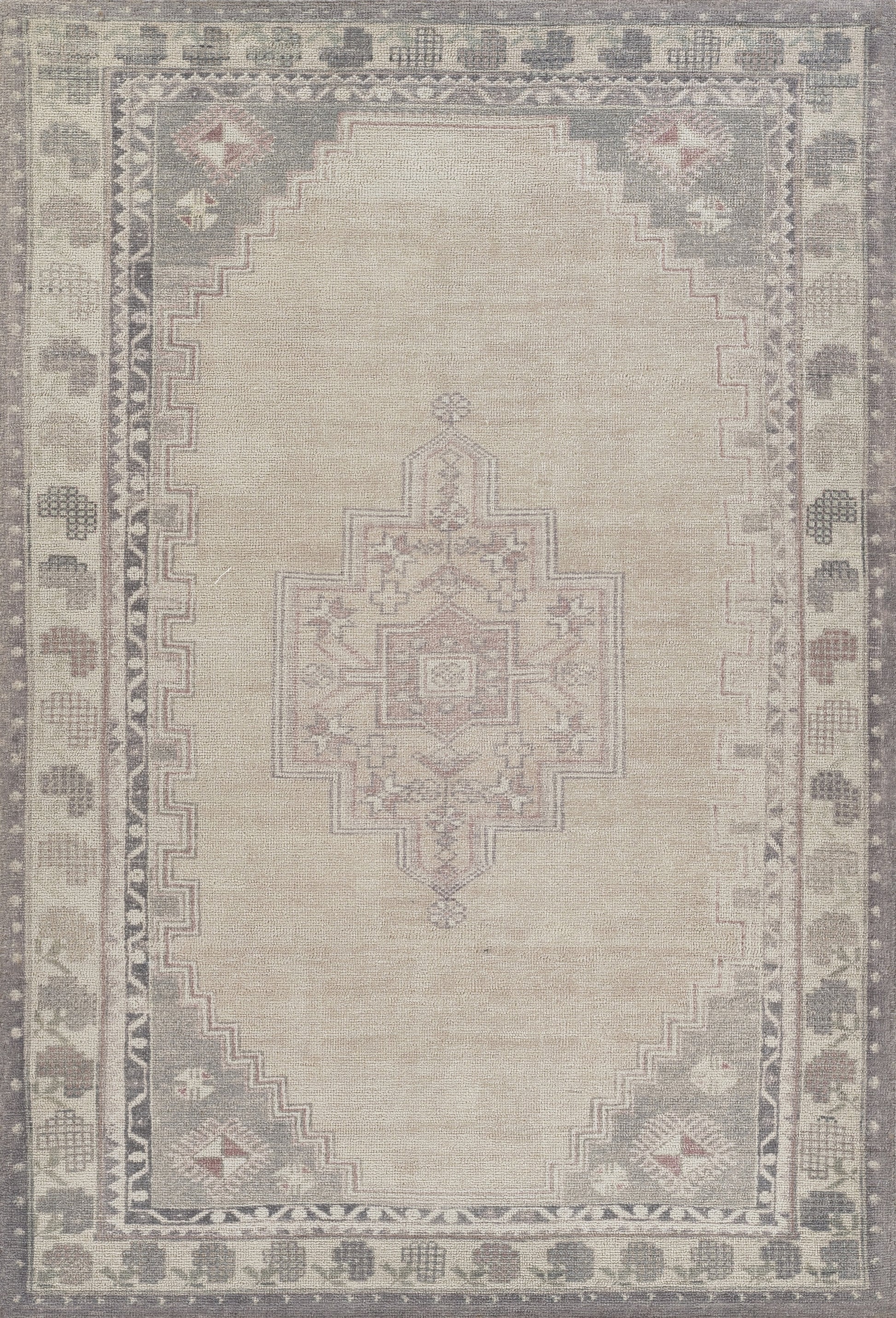 Neutral-toned area rug with pale central medallion, geometric borders, ivory field, and subtle grey-pink accents.