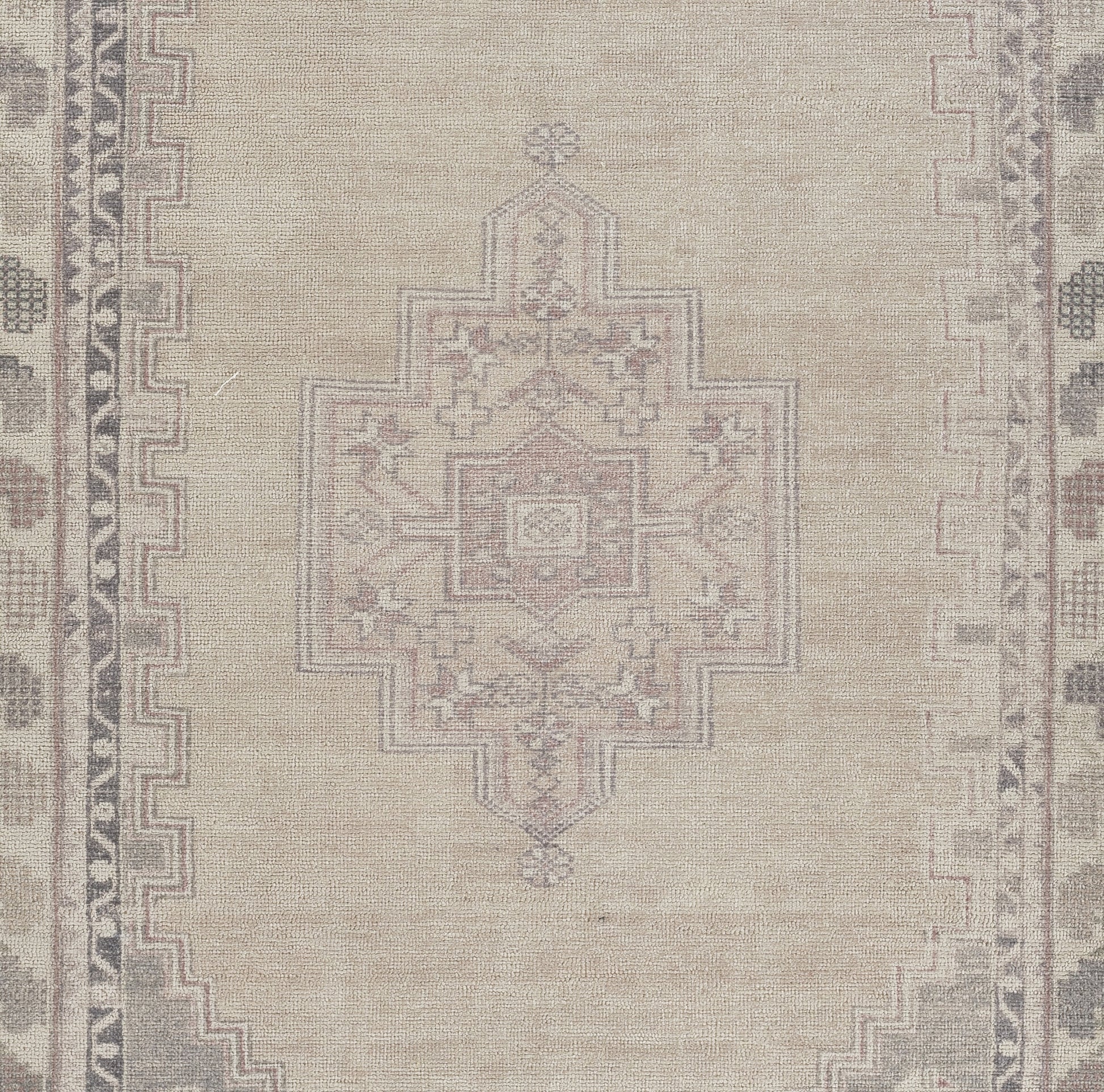 Beige oriental rug with pale pink-gray geometric medallion & stepped border.