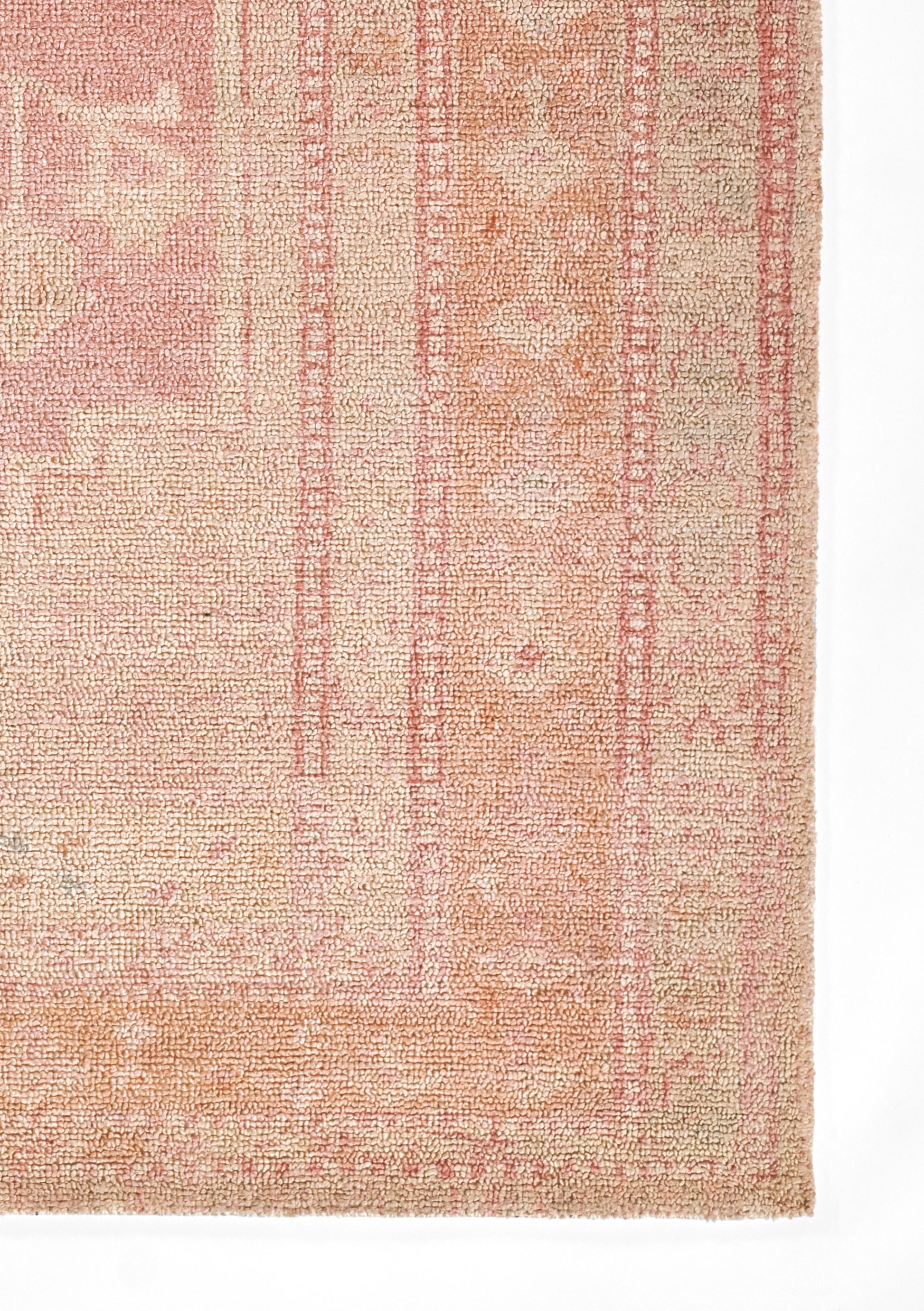Rectangular peach-pink runner with vintage floral borders, soft looped pile and warm cream accents.