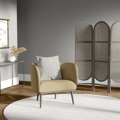 Mustard armchair with light gray cushion, slim legs in a modern living room with a three-panel woven screen, round white rug.