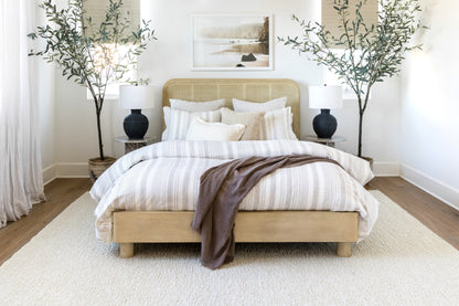 Neutral-toned 6' x 9' rug in a bedroom scene.