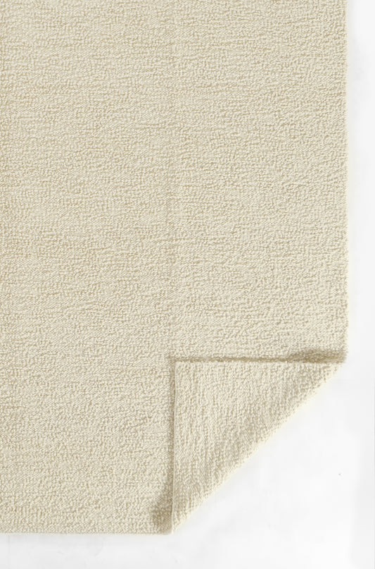 Beige cream textured carpet swatch with a folded corner; plush loop pile, soft rug sample.
