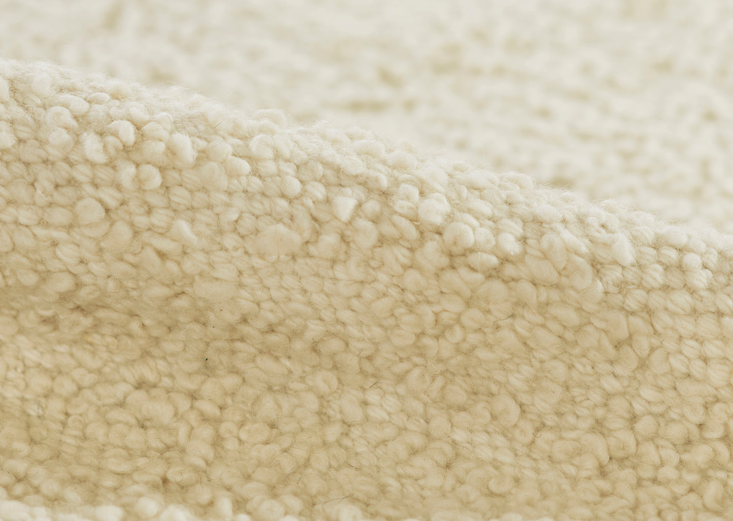 Cream rug featuring sherpa fleece and dense boucle texture; plush, cozy, warm, 6' x 9'.